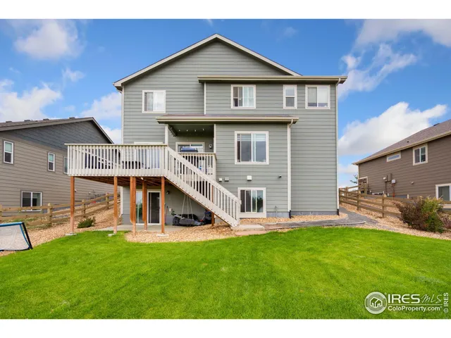 a view of a house with a yard and sitting area