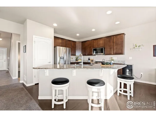 a kitchen with kitchen island and stainless steel appliances