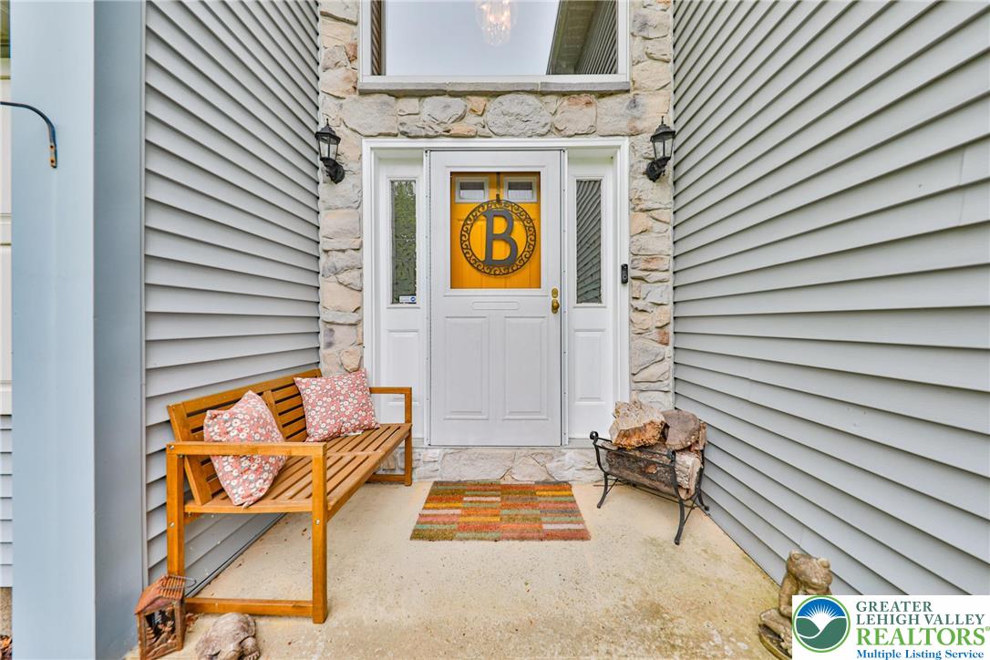 4608 Pine Ridge Drive West Bushkill, PA 18324 - Photo 6 of 62 A welcoming entry featuring stone accents and classic siding, creating inviting curb appeal.