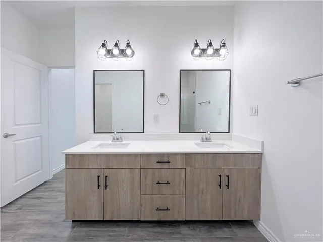 a bathroom with a double vanity sink mirror and
