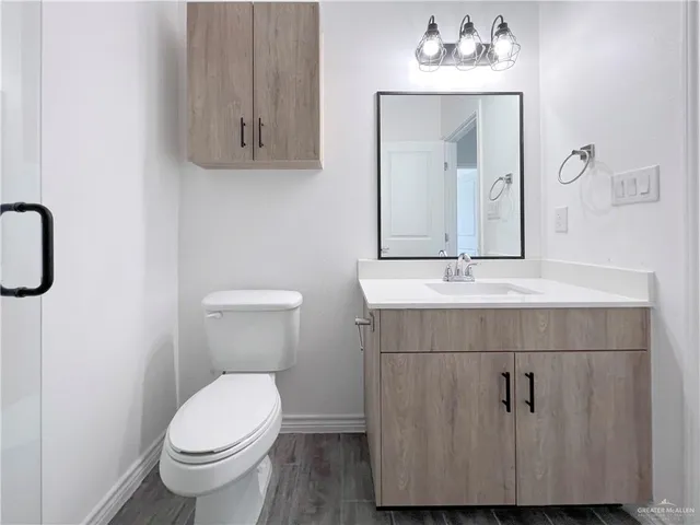 a bathroom with a sink vanity and toilet