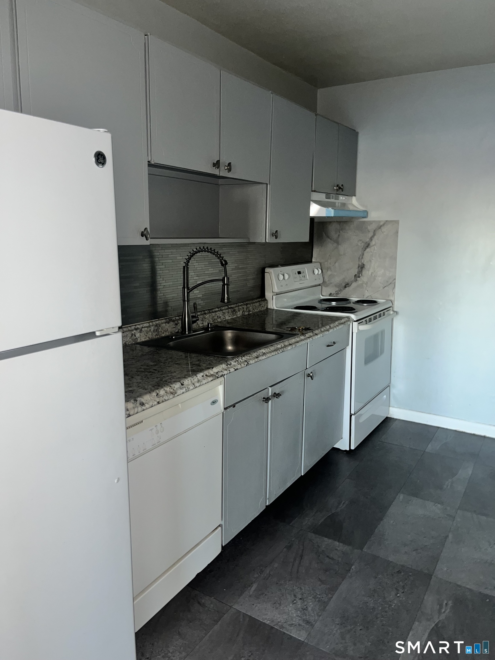 1730 State Street, Unit 407 Hamden, CT 06517 - Photo 2 of 8 a kitchen with stainless steel appliances granite countertop a sink stove and refrigerator
