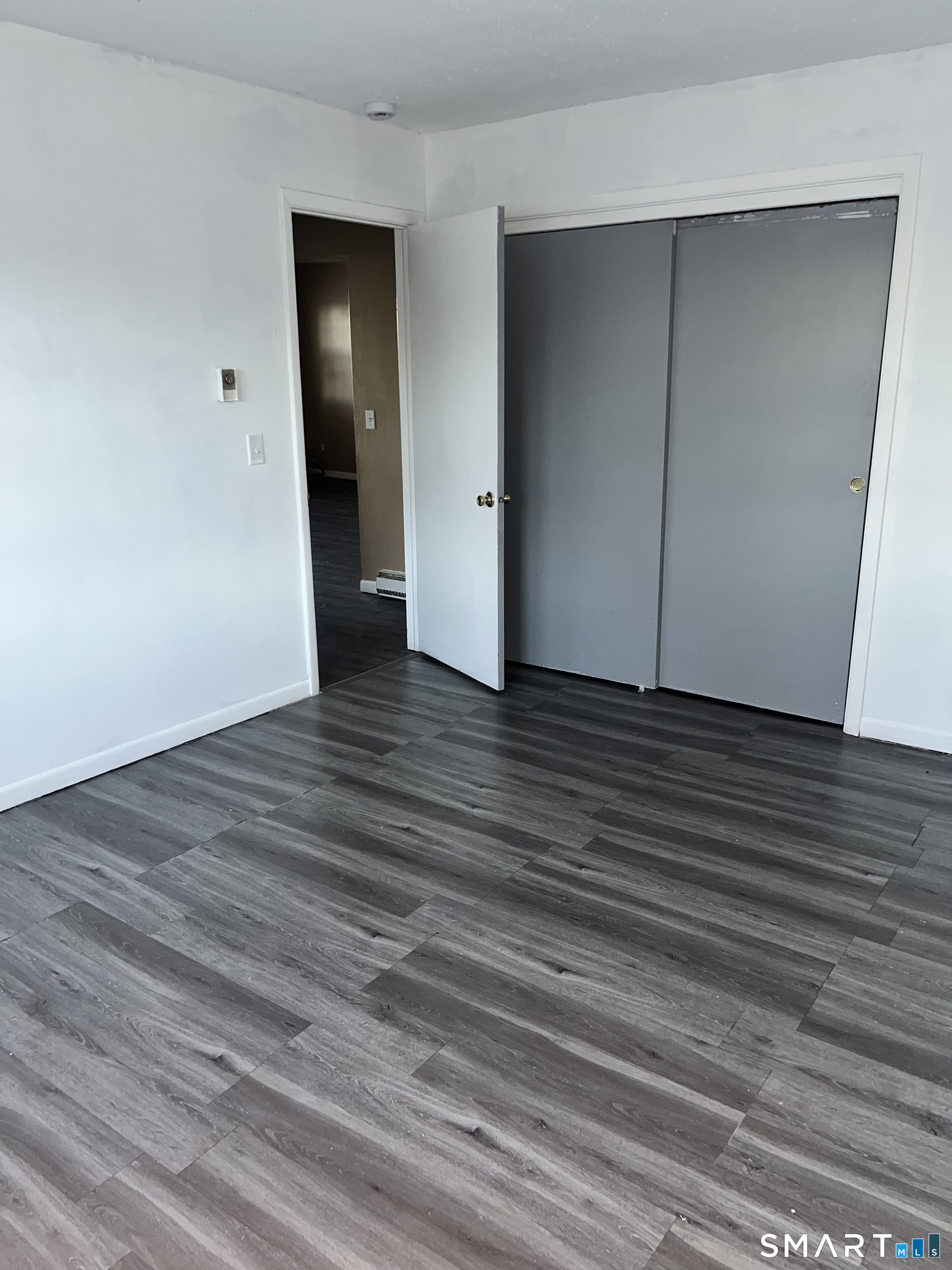 1730 State Street, Unit 407 Hamden, CT 06517 - Photo 6 of 8 a view of an empty room with wooden floor