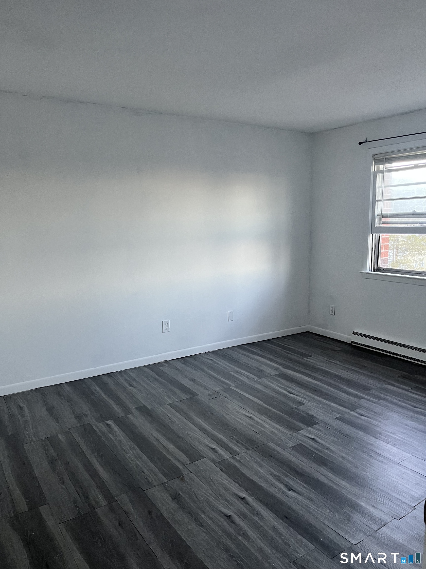1730 State Street, Unit 407 Hamden, CT 06517 - Photo 7 of 8 a view of an empty room and window
