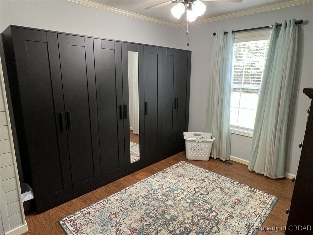 102 Mechams Cove Road Topping, VA 23169 - Photo 28 of 40 Bedroom featuring ornamental molding, wood finished floors, and a ceiling fan