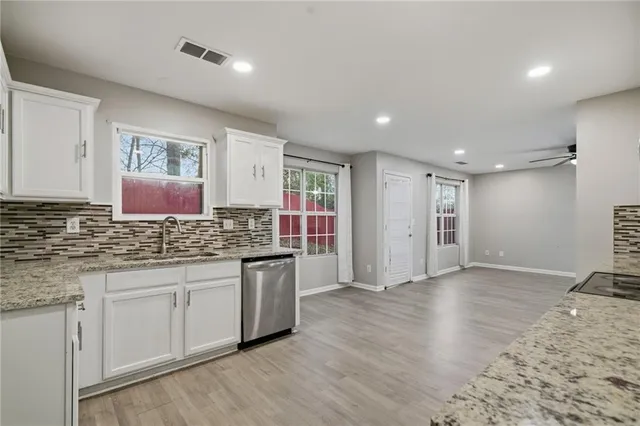 a kitchen with stainless steel appliances granite countertop a sink and stove top oven