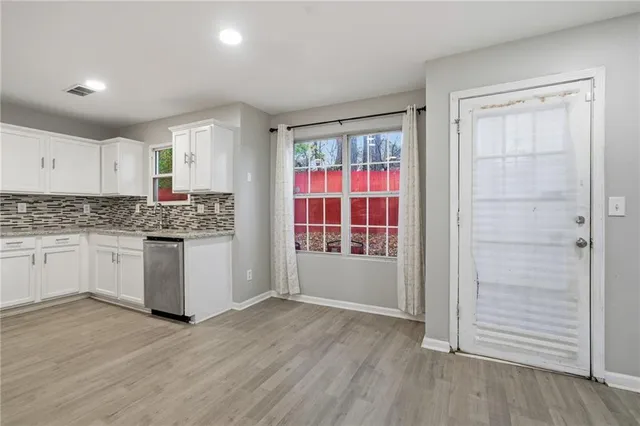 a kitchen with granite countertop white cabinets and white appliances