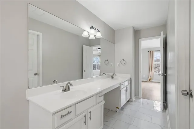 a bathroom with a sink vanity and a mirror