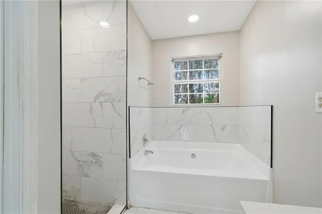 a bathroom with a bathtub and shower
