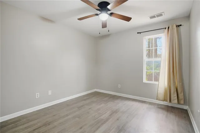 wooden floor in an empty room with a window