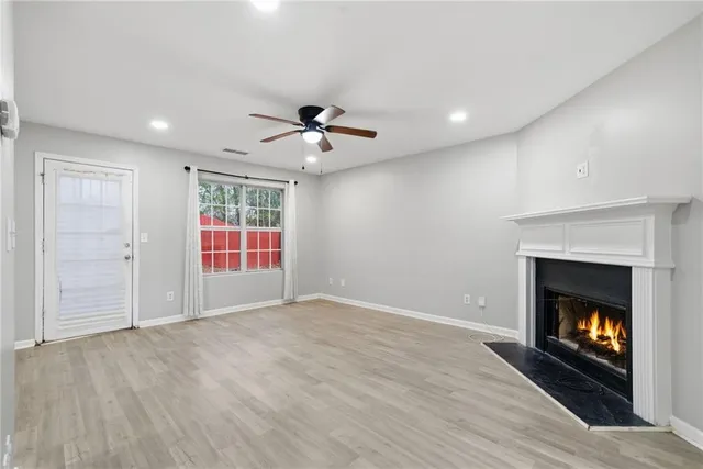 a view of an empty room and fire place