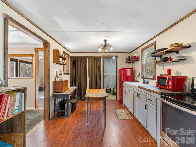 a open kitchen with stainless steel appliances granite countertop a stove and cabinets with wooden floor