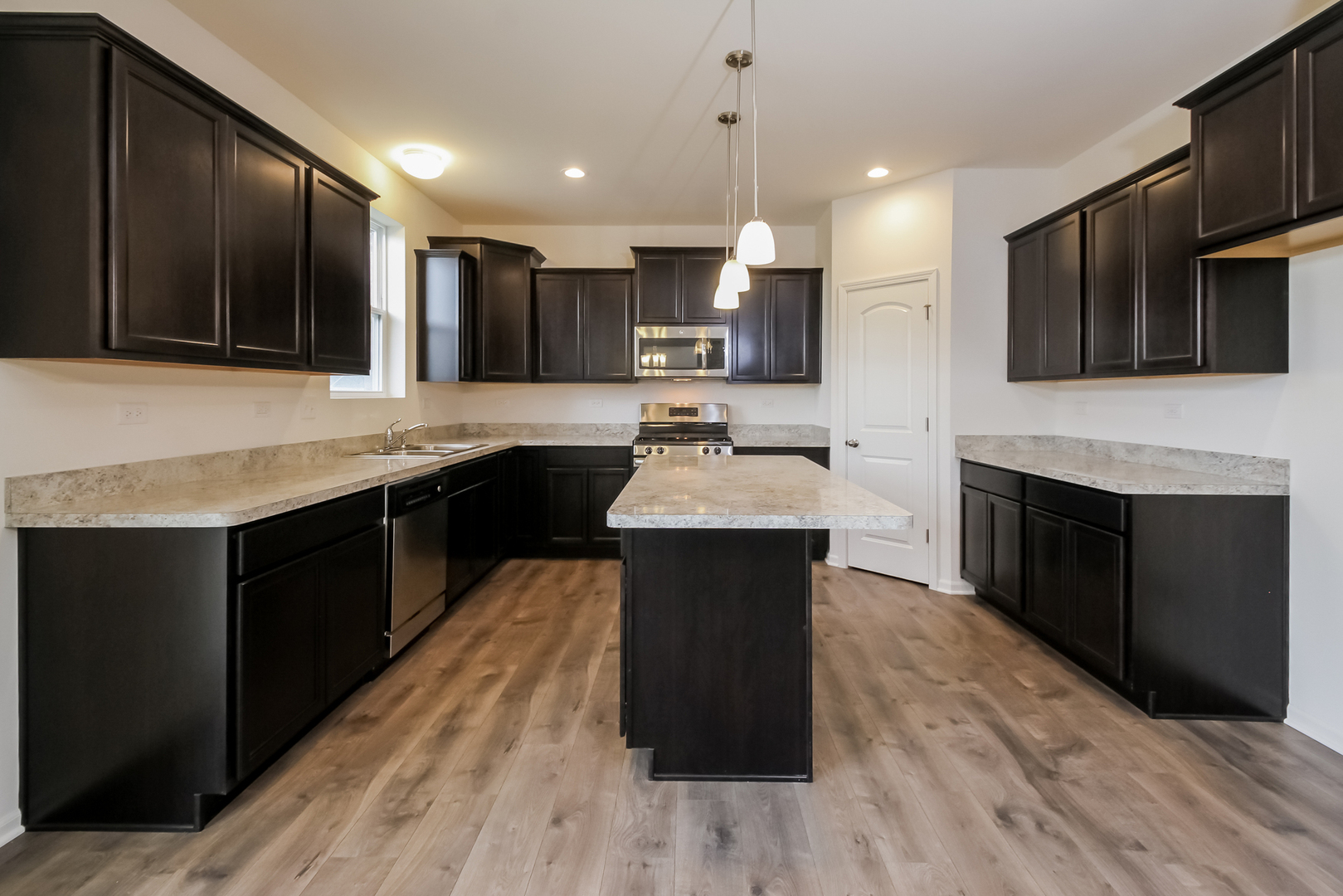 1994 Stapleton Road New Lenox, IL 60451 - Photo 2 of 16 a kitchen with stainless steel appliances kitchen island granite countertop a stove top oven a sink and a microwave