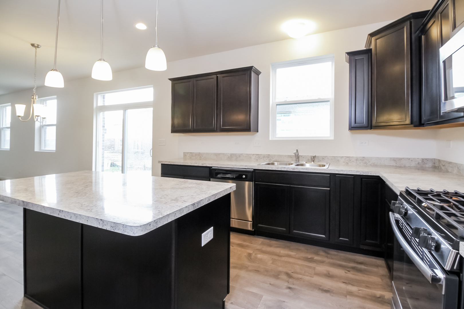 1994 Stapleton Road New Lenox, IL 60451 - Photo 3 of 16 a kitchen with a sink and a stove top oven with wooden floor