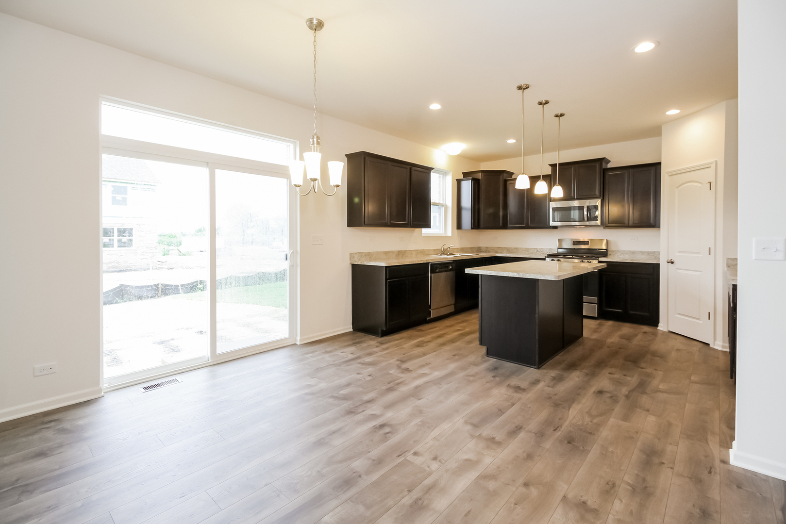1994 Stapleton Road New Lenox, IL 60451 - Photo 5 of 16 a view of kitchen with stainless steel appliances granite countertop a sink and cabinets