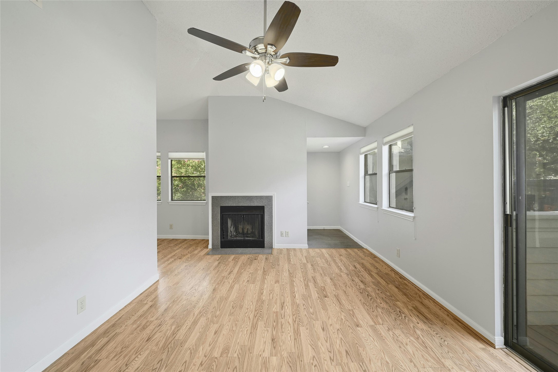 9226 Jollyville Road, Unit 221 Austin, TX 78759 - Photo 20 of 20 A vaulted ceiling, warm wood floors, and a stone fireplace create a harmonious living space.