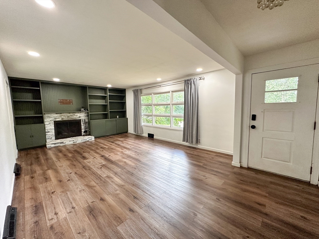 3 Intervale Road Springfield, MA 01118 - Photo 10 of 22 an empty room with kitchen fireplace and windows