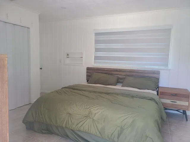 a bed with a bed and a chair