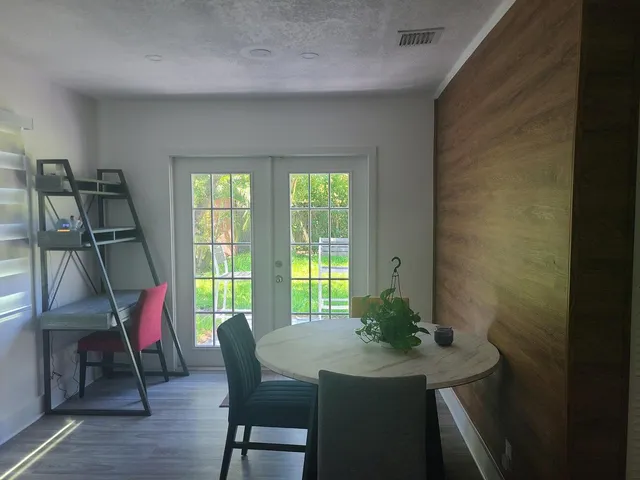 a dining room with furniture and wooden floor