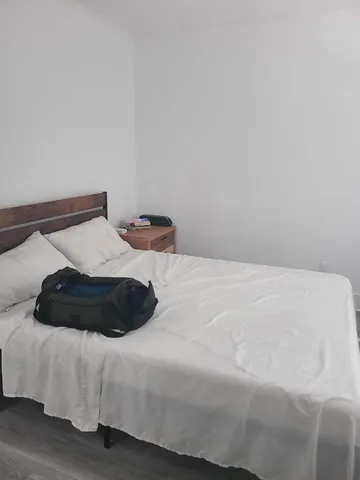 a bedroom with a bed and a night stand