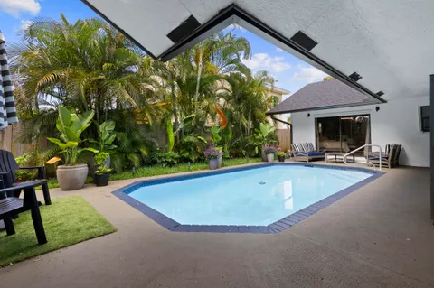 a view of a backyard with swimming pool