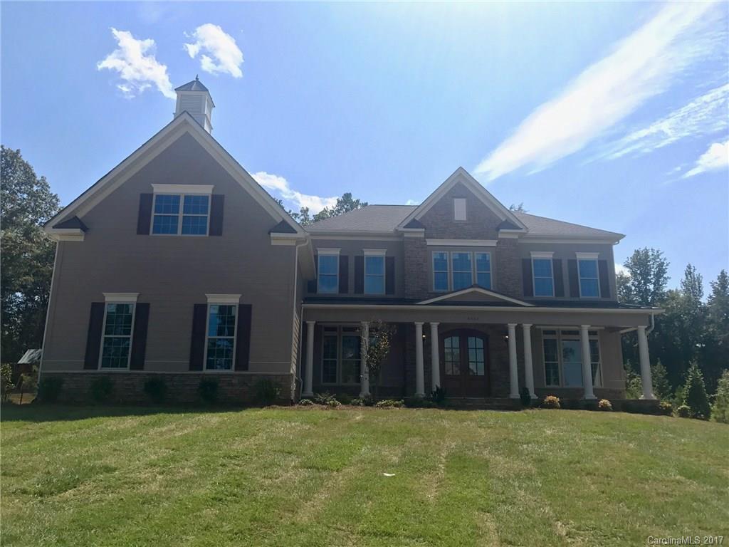 4013 Flowering Peach Road, Unit 9 Marvin, NC 28173 - Photo 1 of 12 a front view of a house with a yard