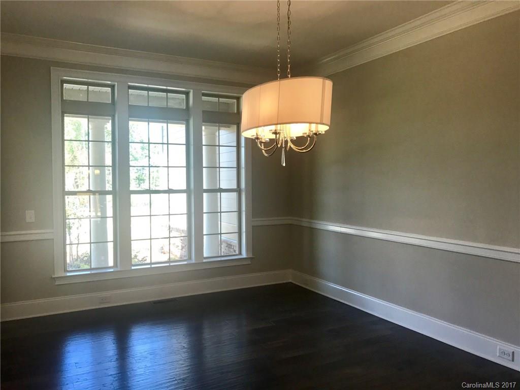 4013 Flowering Peach Road, Unit 9 Marvin, NC 28173 - Photo 4 of 12 an empty room with wooden floor and windows