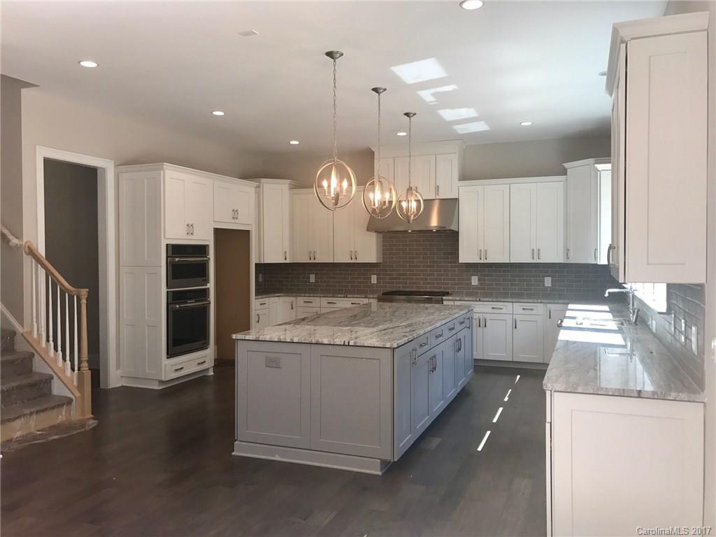 4013 Flowering Peach Road, Unit 9 Marvin, NC 28173 - Photo 7 of 12 a large kitchen with stainless steel appliances granite countertop a sink a stove and a refrigerator