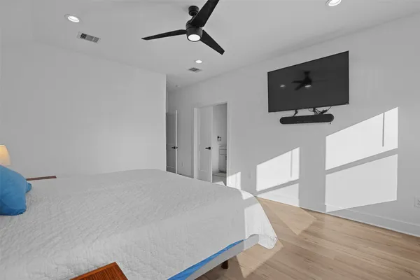 a bedroom with a bed and a flat screen tv