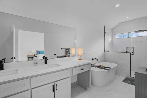 a bathroom with a double vanity sink mirror and toilet