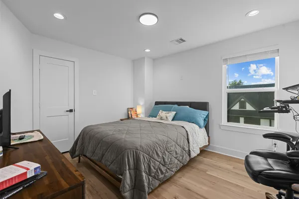 a bedroom with a bed and a flat screen tv