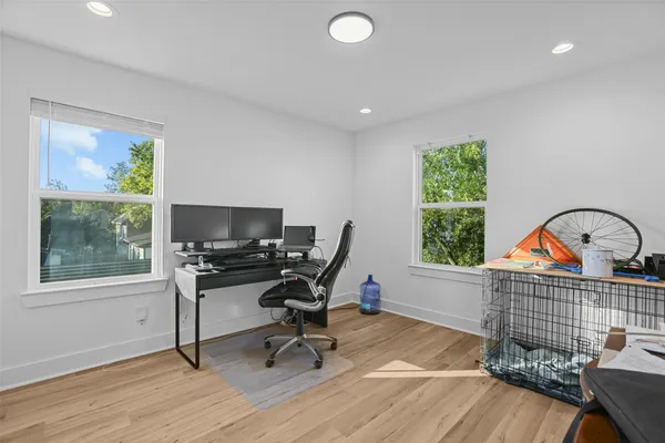 a view of a workspace with furniture and a window