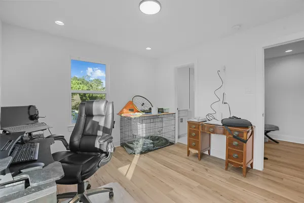 a view of a workspace with furniture and a gym cycle