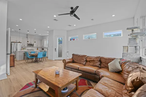 a living room with furniture and kitchen view