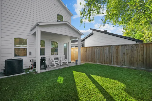 a backyard of a house with table and chairs