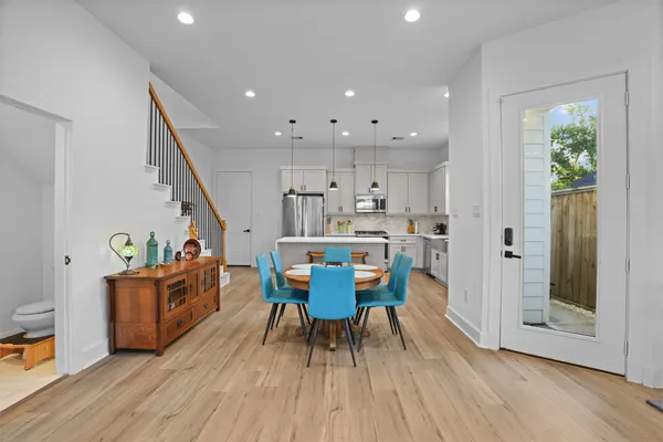 a dining room with furniture and wooden floor