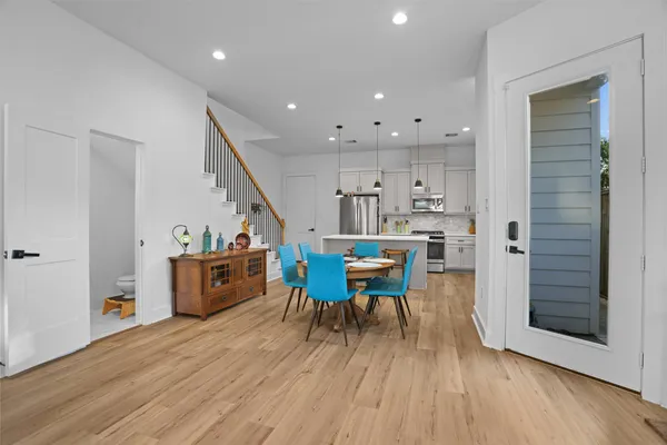 a dining room with furniture and wooden floor