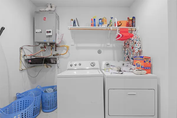 a utility room with a sink washer and dryer