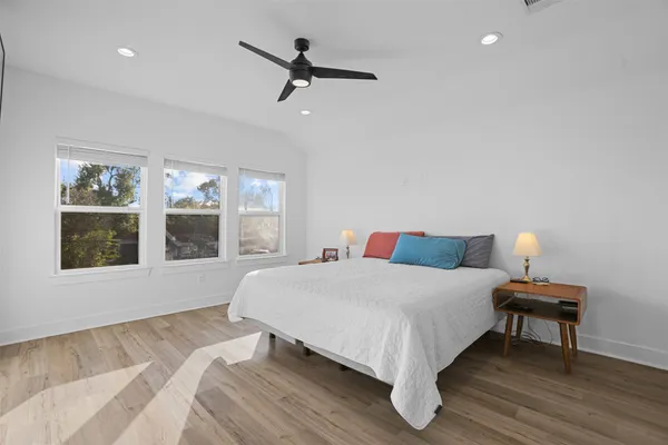 a large bed sitting in a bedroom next to a window