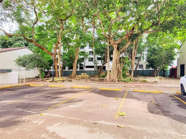 a view of a pool with a lawn chairs