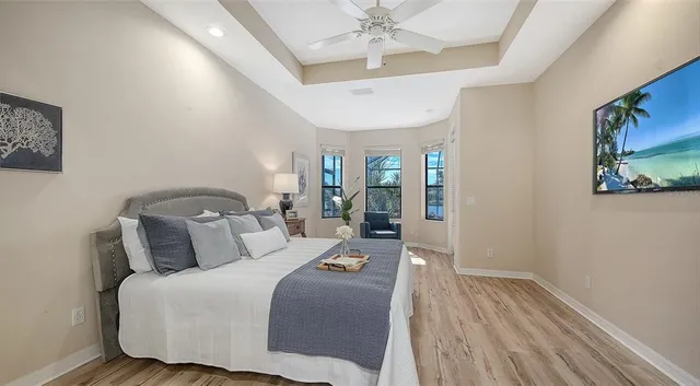 a bedroom with a bed and a lamp on the dresser