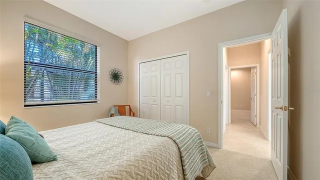 a view of an empty room with closet and a window