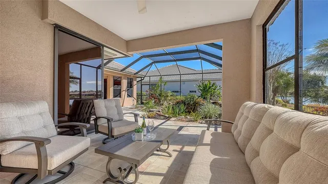 a view of a patio with table and chairs under an umbrella