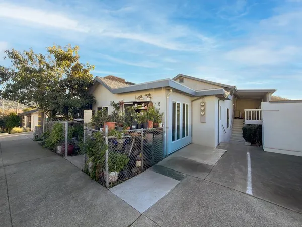 a view of a house with floor to ceiling windows and a basket ball poll