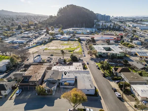 an aerial view of residential houses with outdoor space