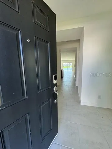 a view of a hallway with wooden floor and closet