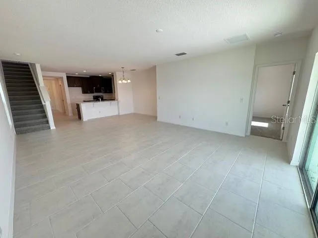 a view of kitchen with sink and refrigerator