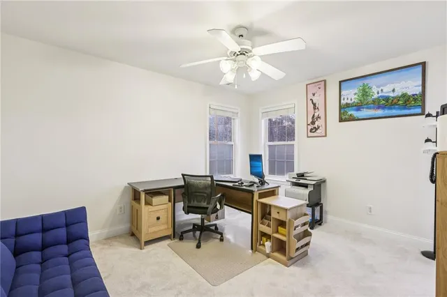 a view of a livingroom with workspace and a couch