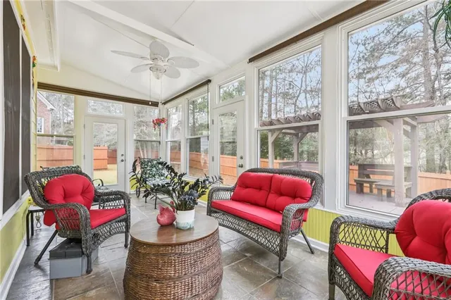 a living room with furniture and a potted plant