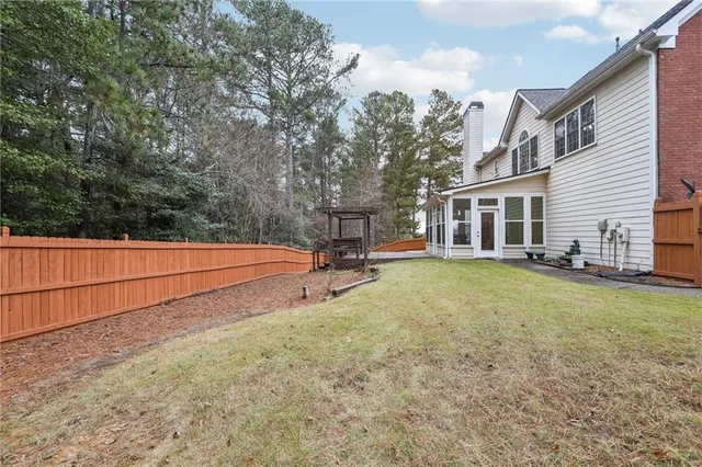 a view of a house with backyard and sitting area